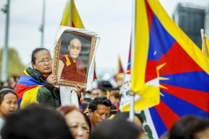 A candid moment of a political rally with passionate supporters waving flags.