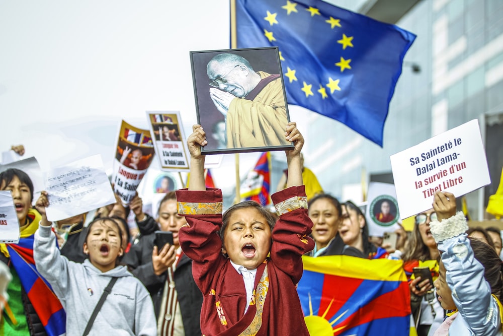 a group of people holding flags and signs