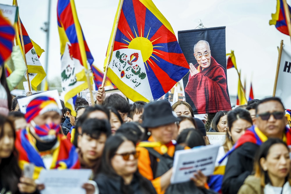 a large group of people holding flags and signs