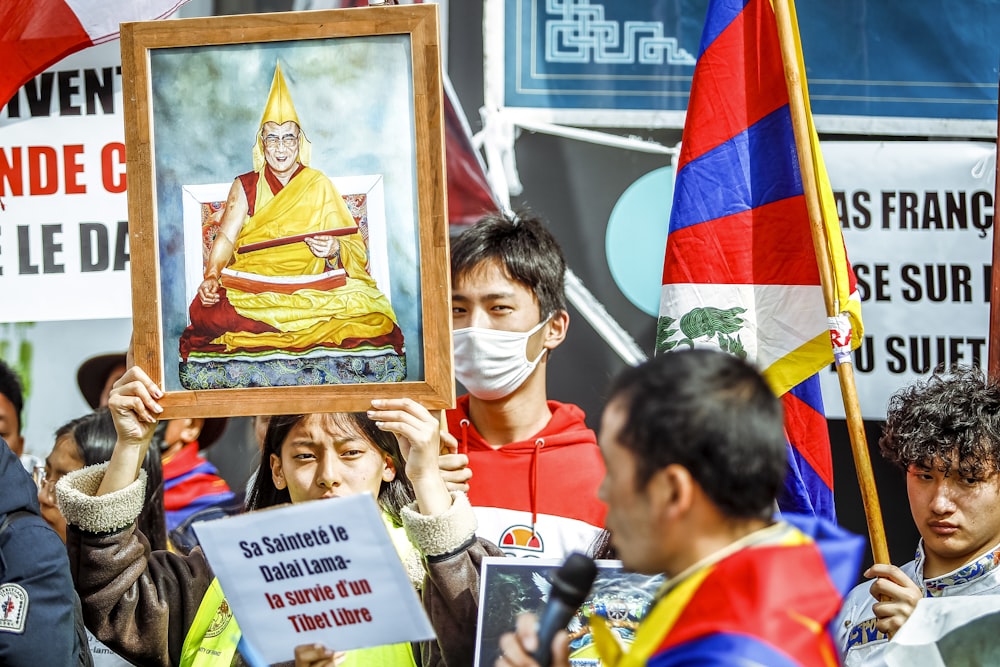 a group of people holding signs and flags