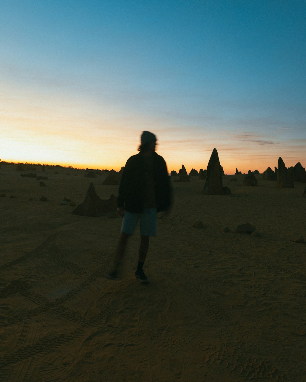 a man standing in the middle of a desert