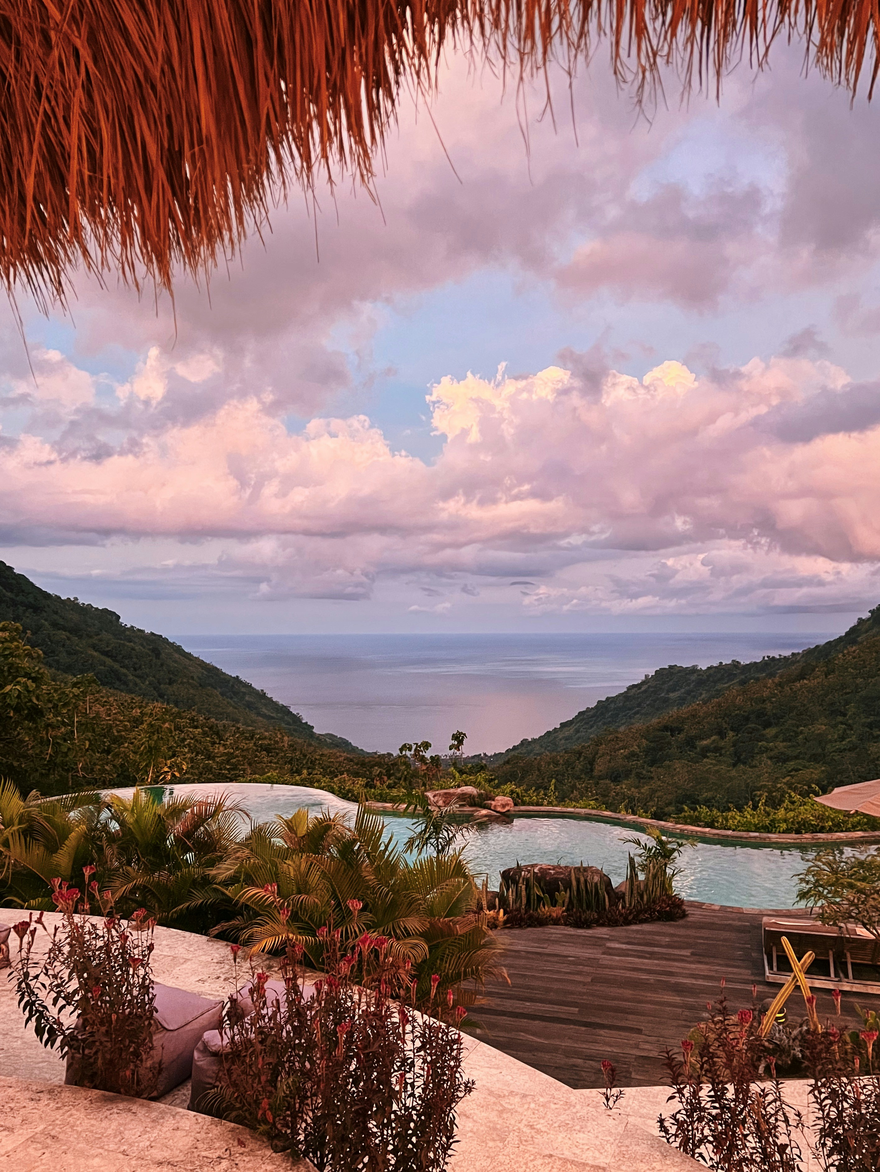 Luxury Himalayan resort with infinity pool overlooking mountain valley at sunset