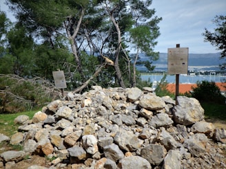 a pile of rocks with a sign in the background