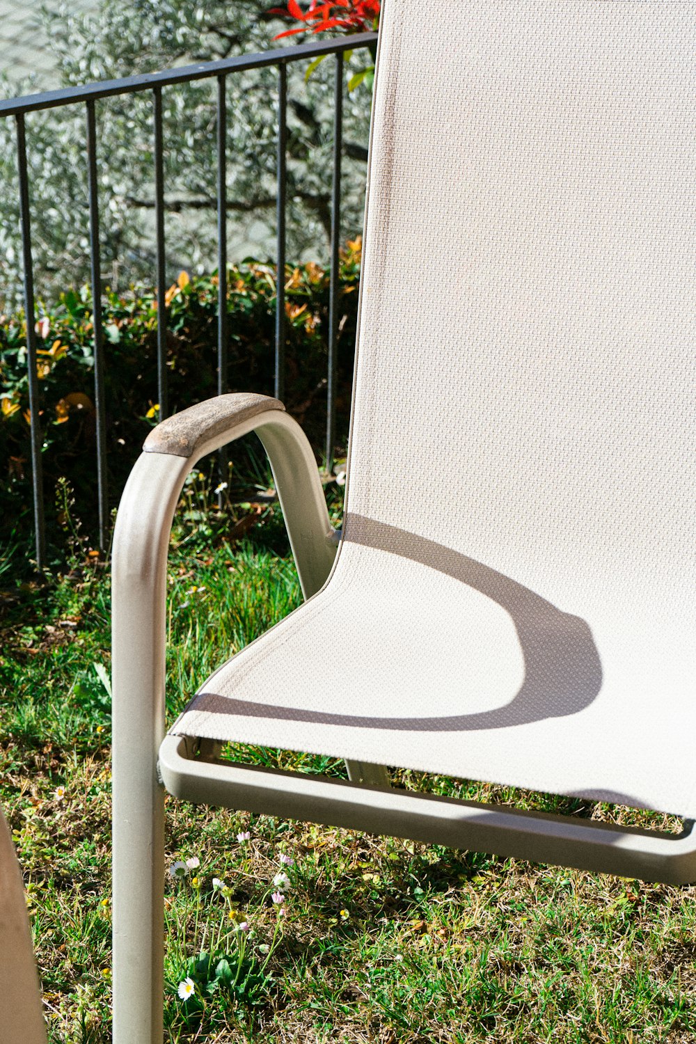 a white chair sitting on top of a lush green field