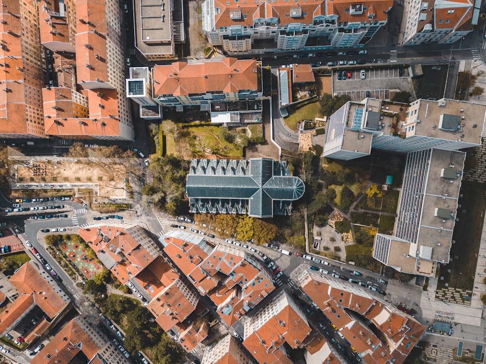 an aerial view of a city with red roofs