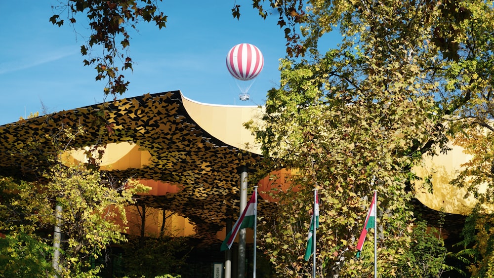 a hot air balloon flying over a building