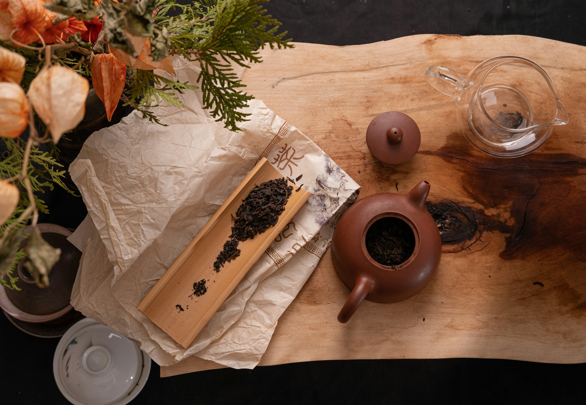 a wooden table topped with a vase filled with flowers