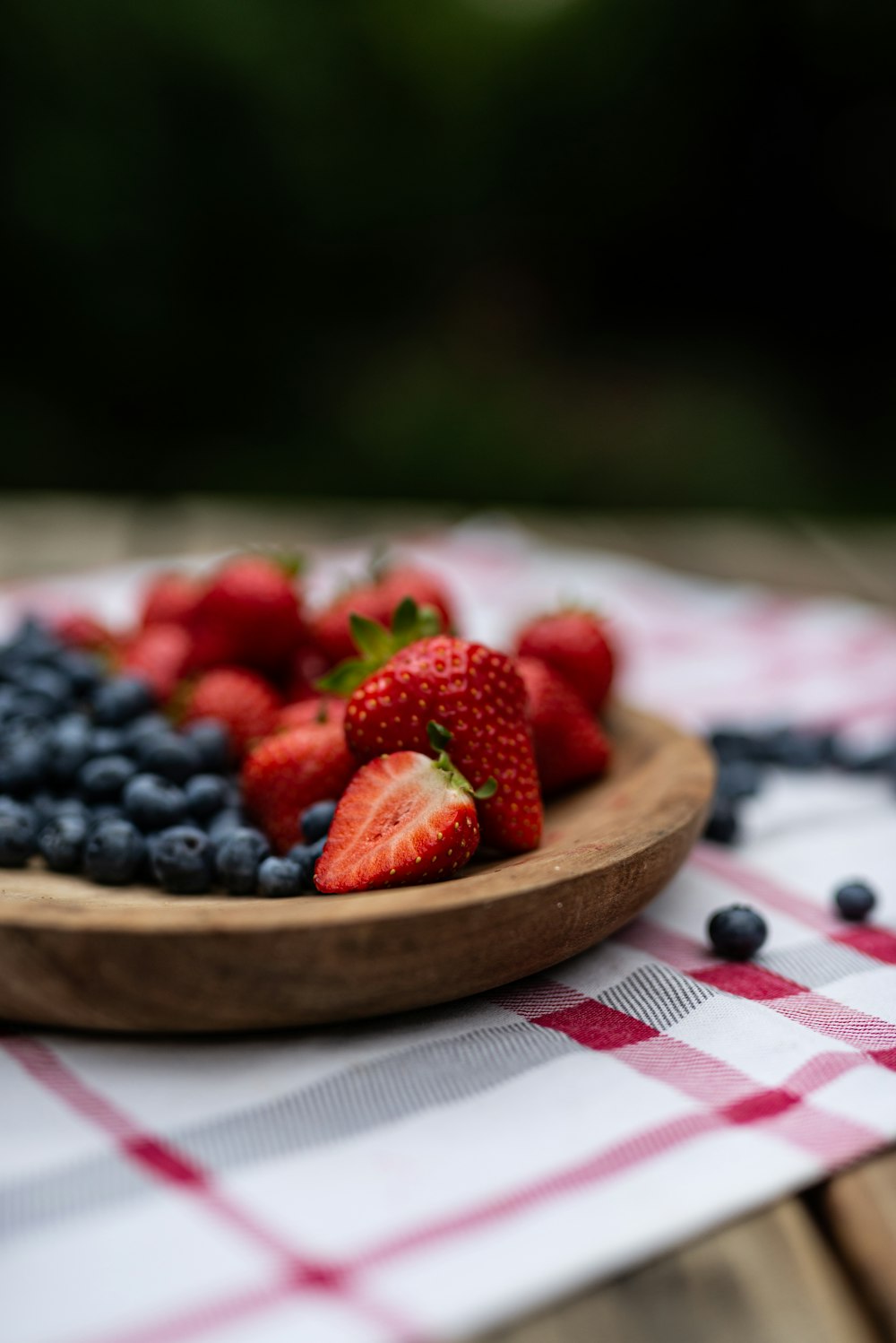 a bowl of strawberries and blueberries on a table