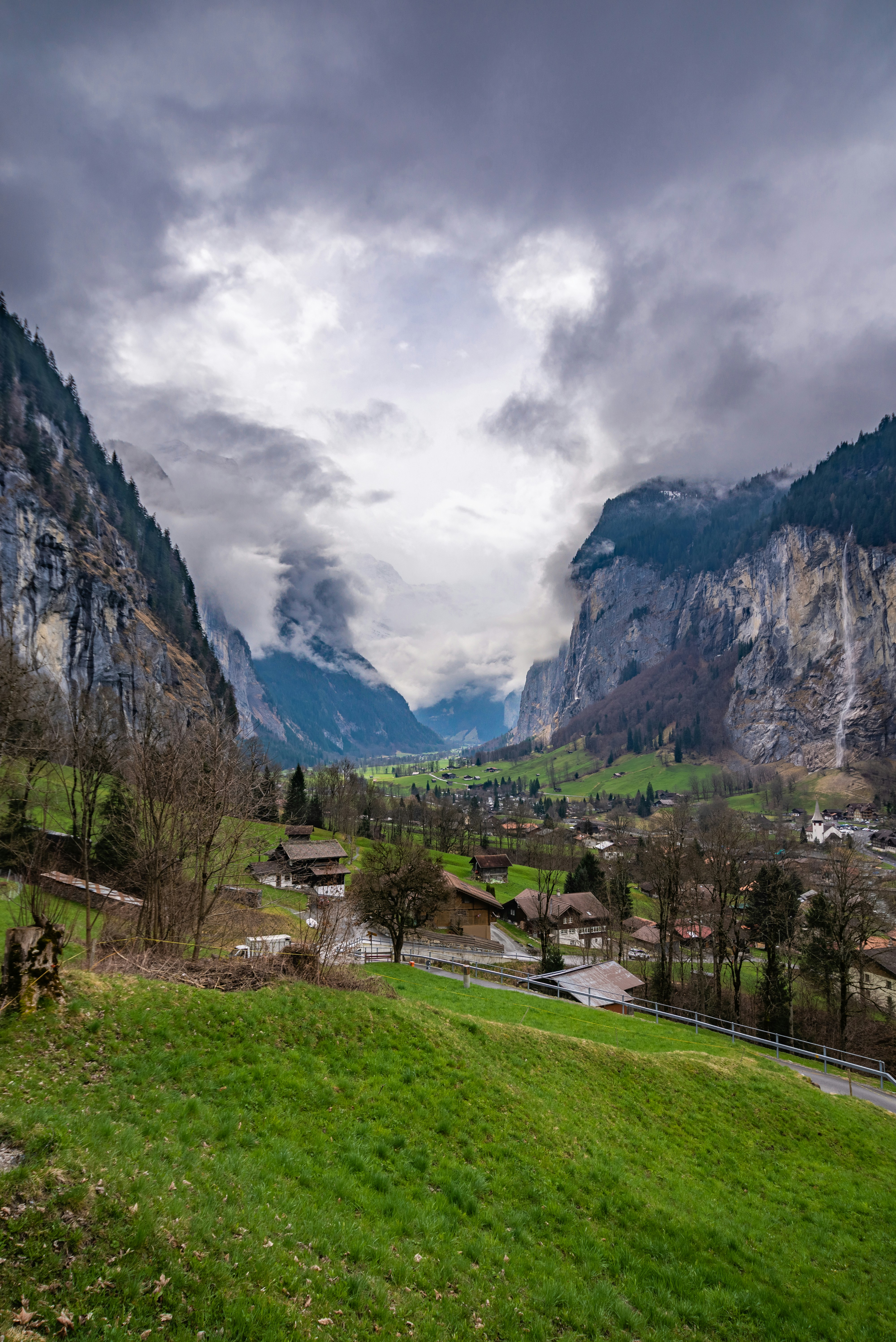 a scenic view of a valley with mountains in the background