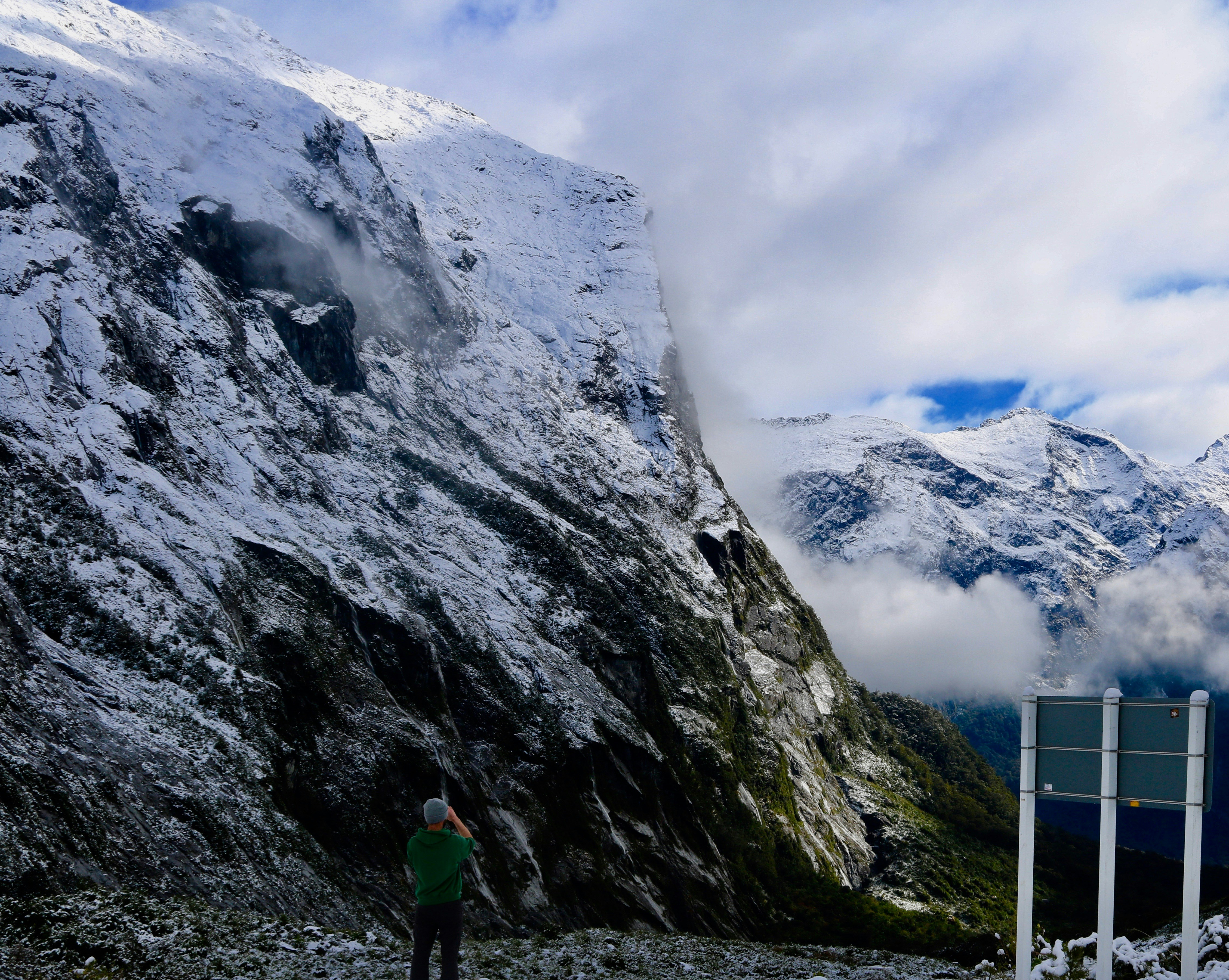a man standing on top of a snow covered mountain