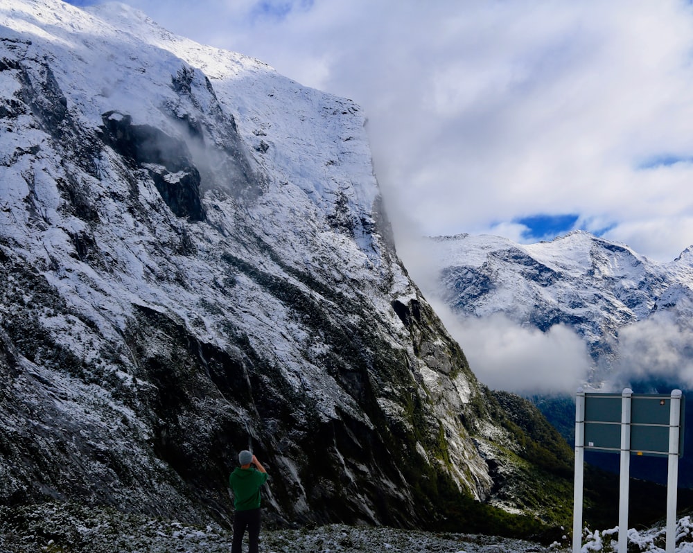 a man standing on top of a snow covered mountain