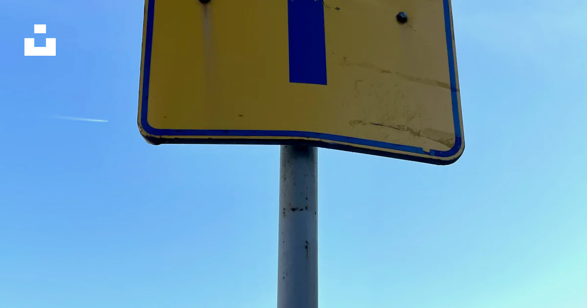 A blue and yellow street sign with the number one on it photo – Free ...