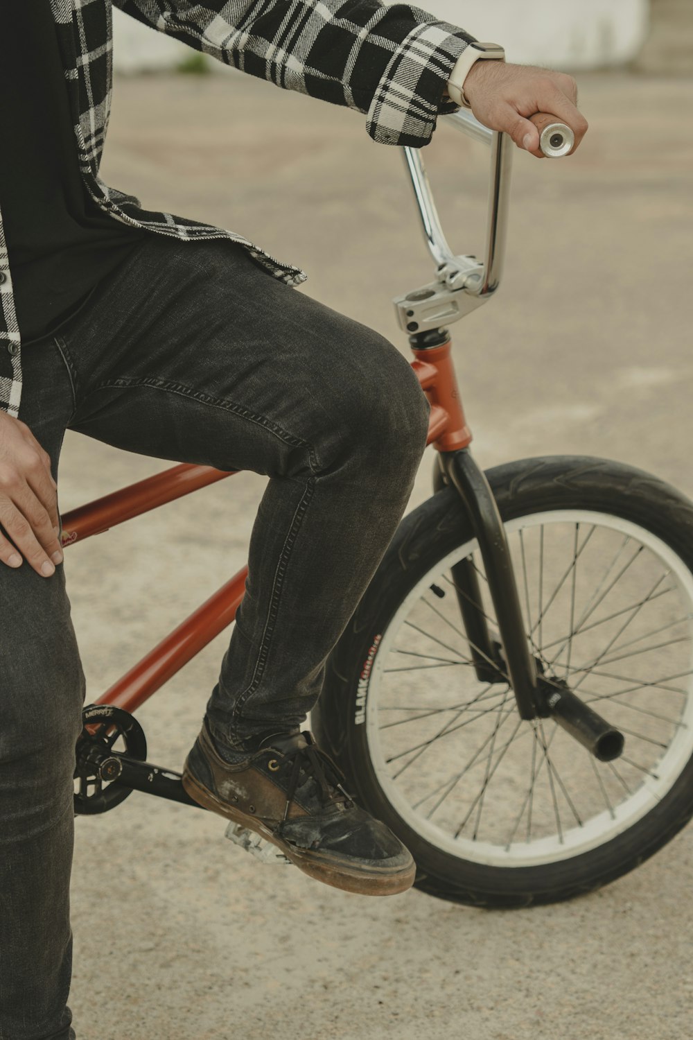 a man sitting on top of a red bike