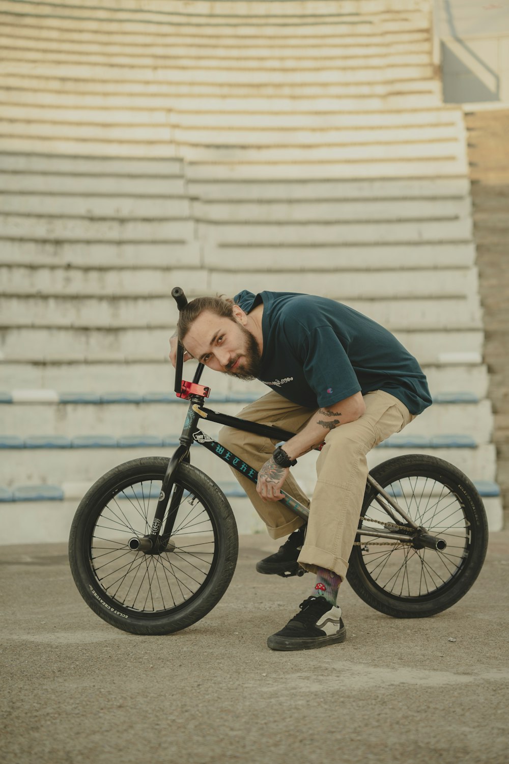 a man riding a bike in front of a bleachers