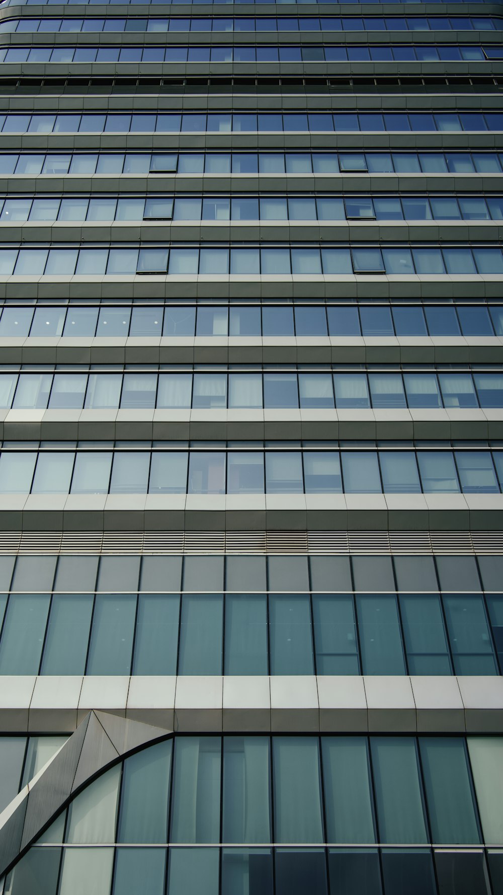 a very tall building with many windows and a clock