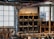 An organized shelf displaying various machine spare parts in a clean storage area.