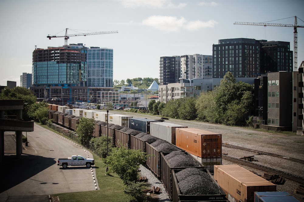 a train traveling through a city next to tall buildings