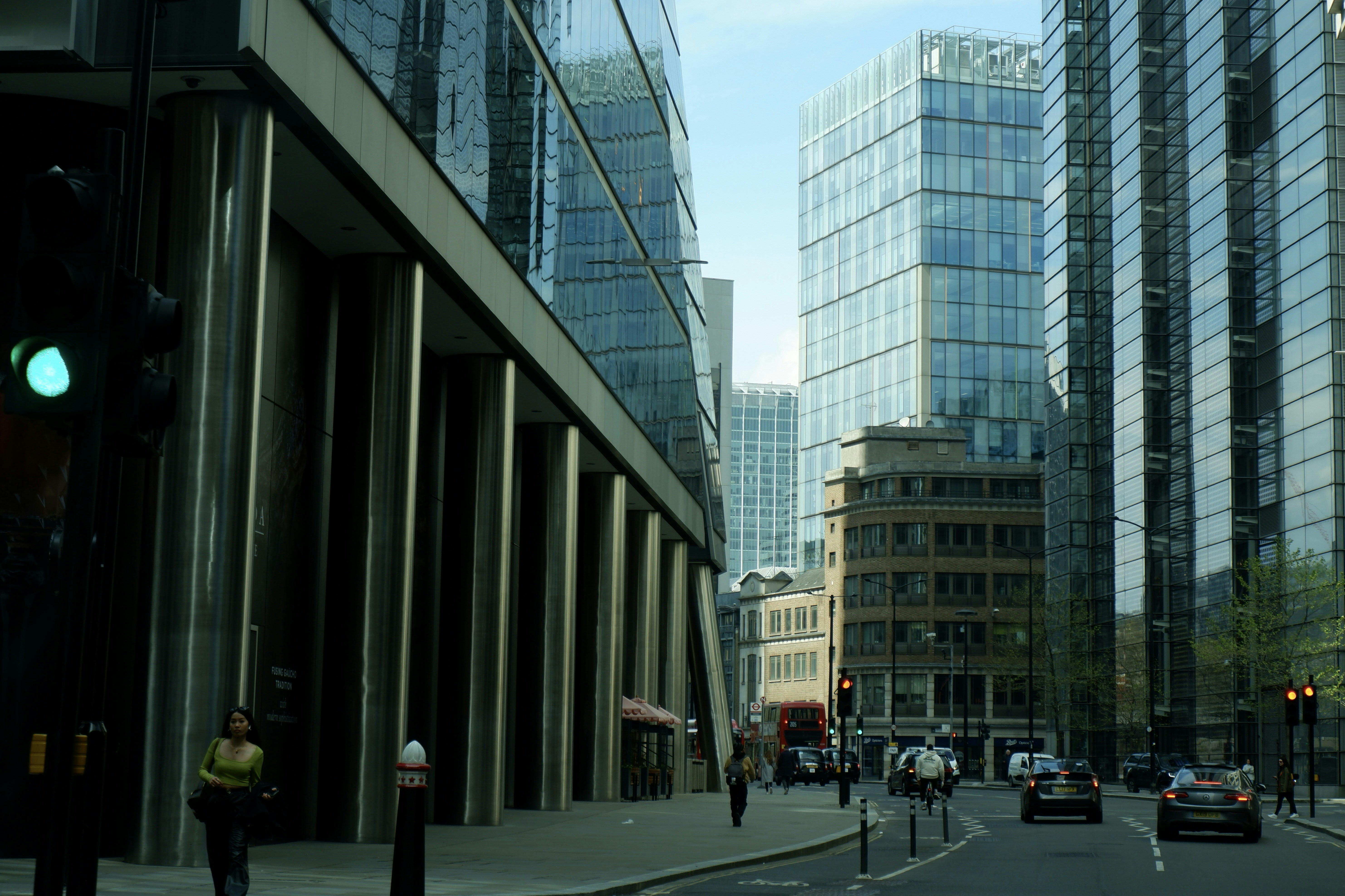 a city street filled with traffic next to tall buildings