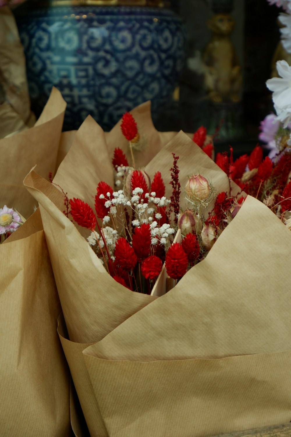 a bunch of flowers that are in some paper bags