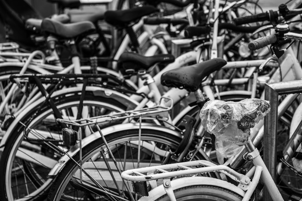 a black and white photo of a bunch of bikes