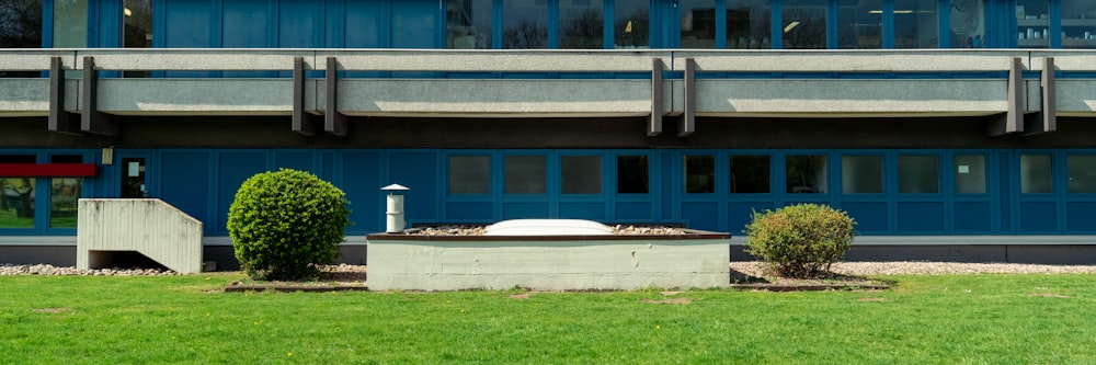 a blue building with a fountain in front of it