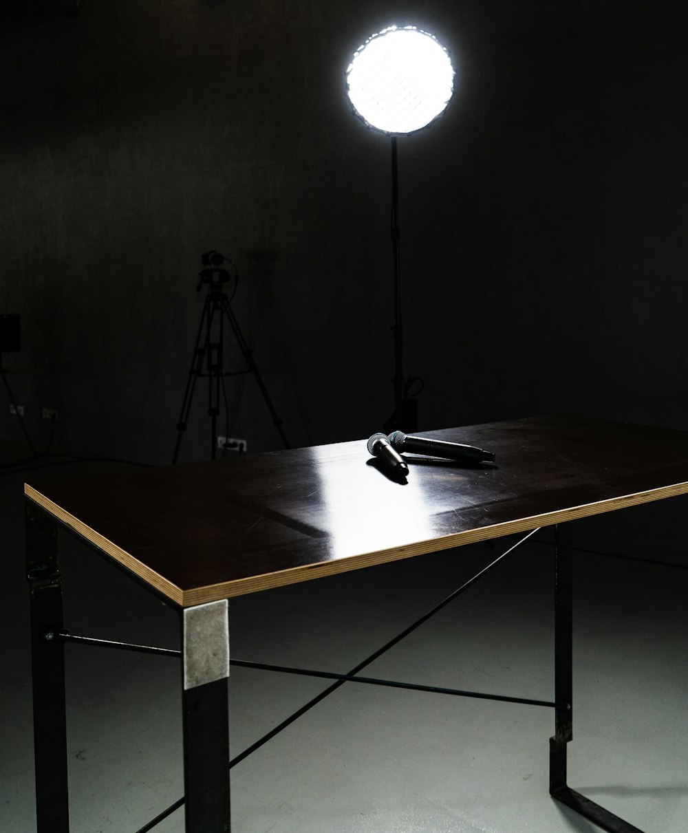 a table with a light on it in a dark room