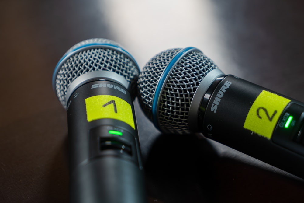 two microphones sitting next to each other on a table