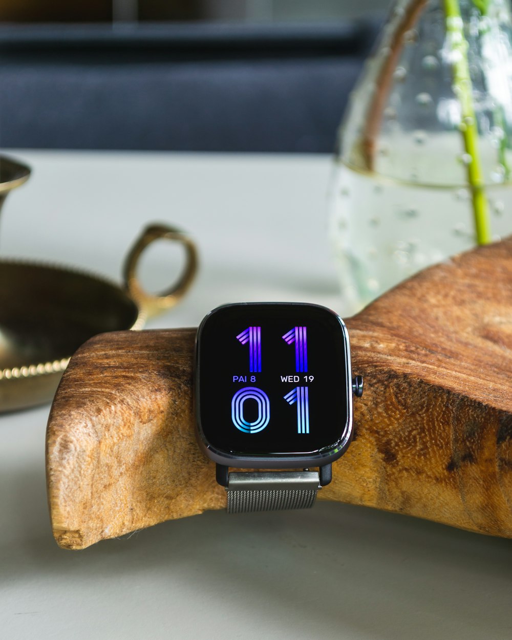 an apple watch sitting on top of a wooden piece of wood