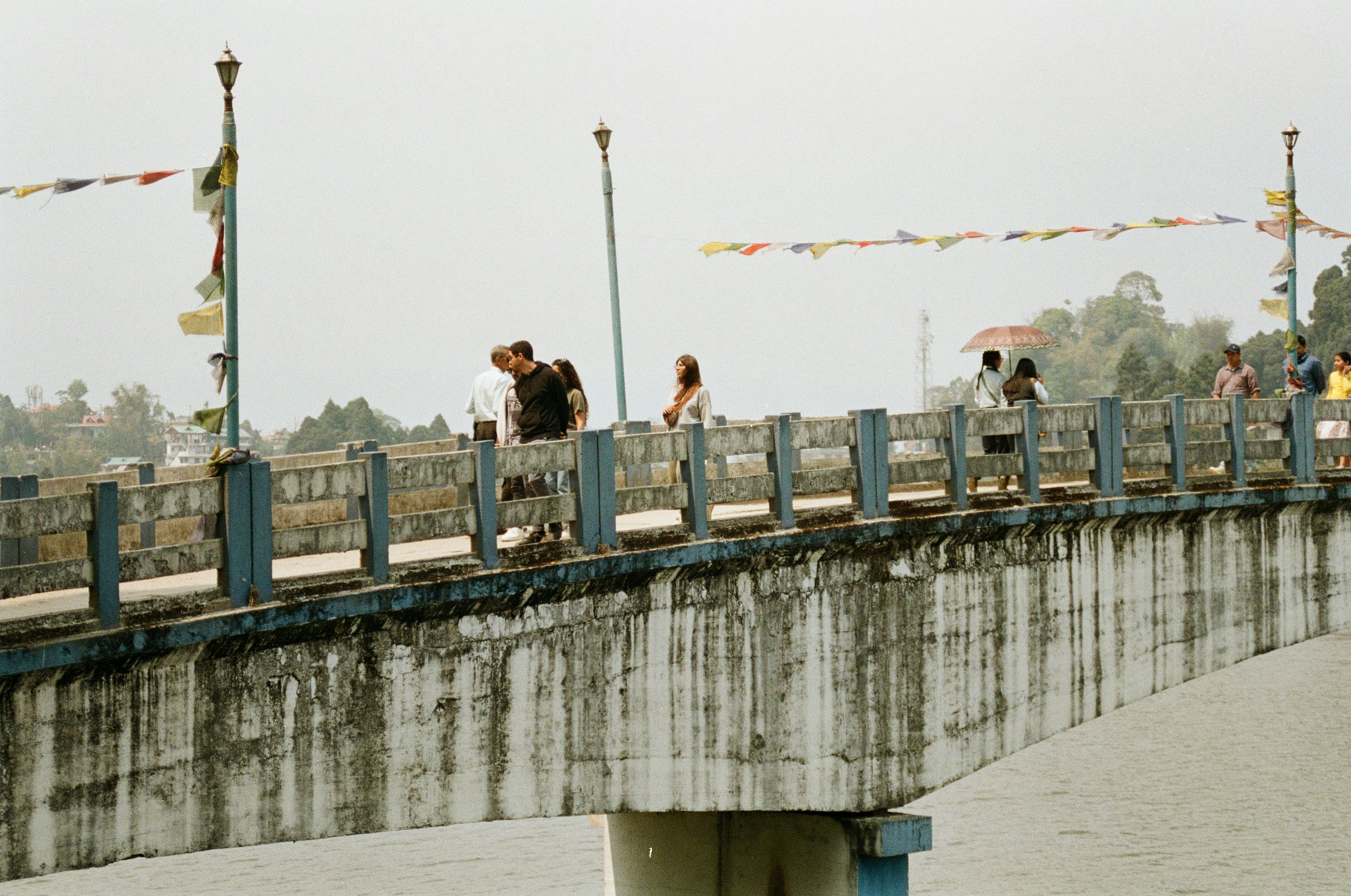 Wide shot of the majestic Vikramshila Setu spanning across the Ganges river, with vehicles crossing it.