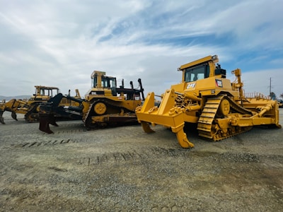 Group of trainees attentively learning about bulldozer operation outdoors