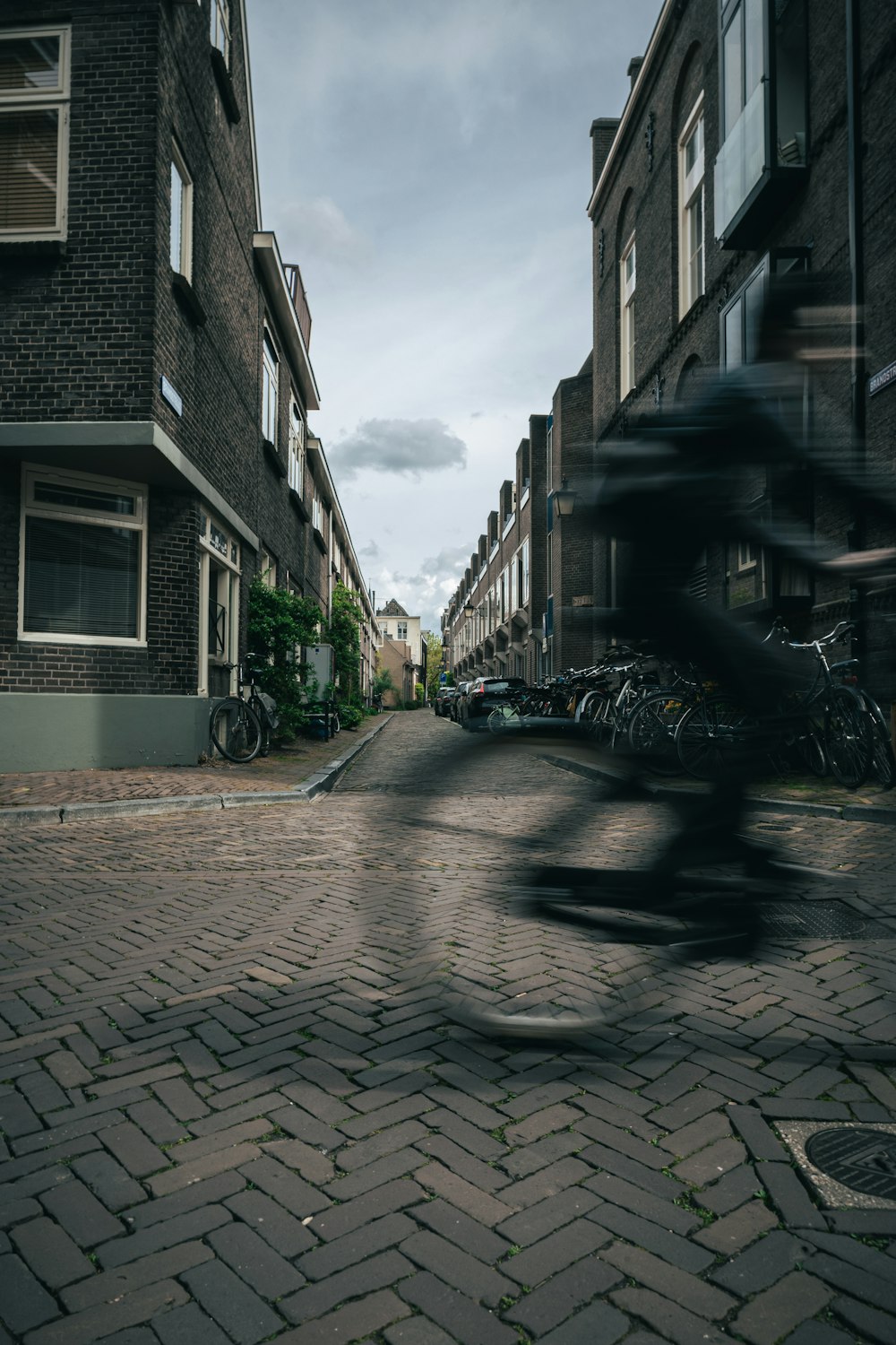 a blurry photo of a person riding a bike down a street