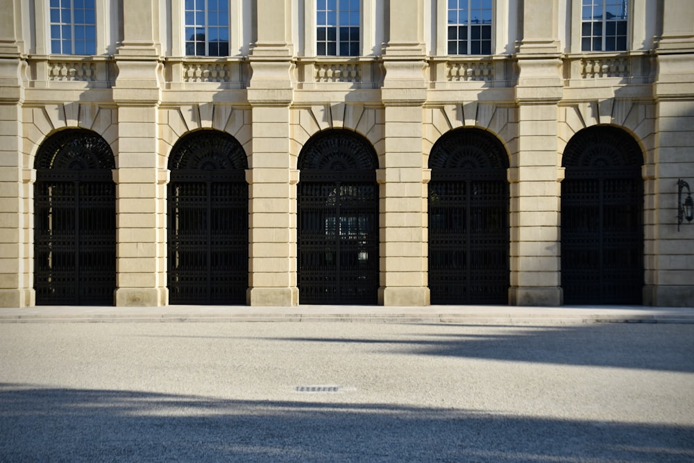 a man riding a skateboard down a street next to a tall building