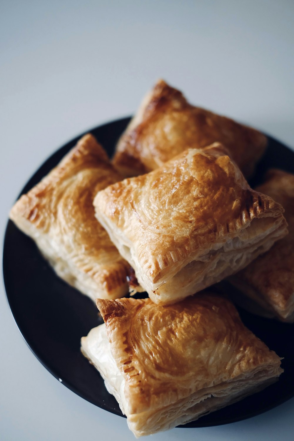 a black plate topped with pastries on top of a table