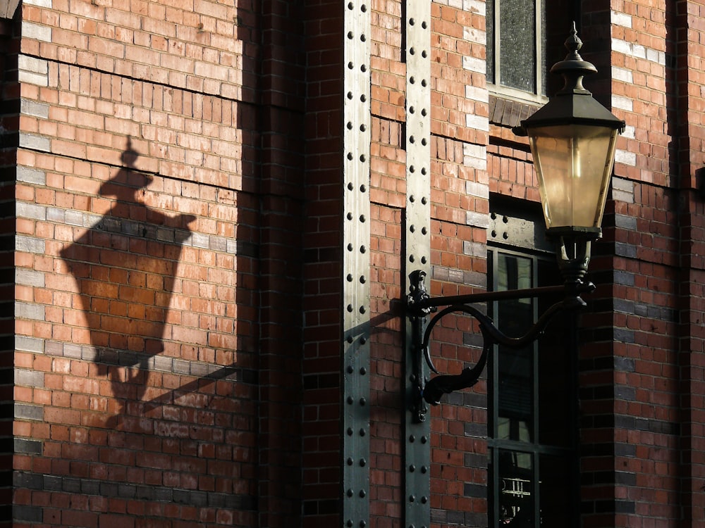 a street light next to a brick building