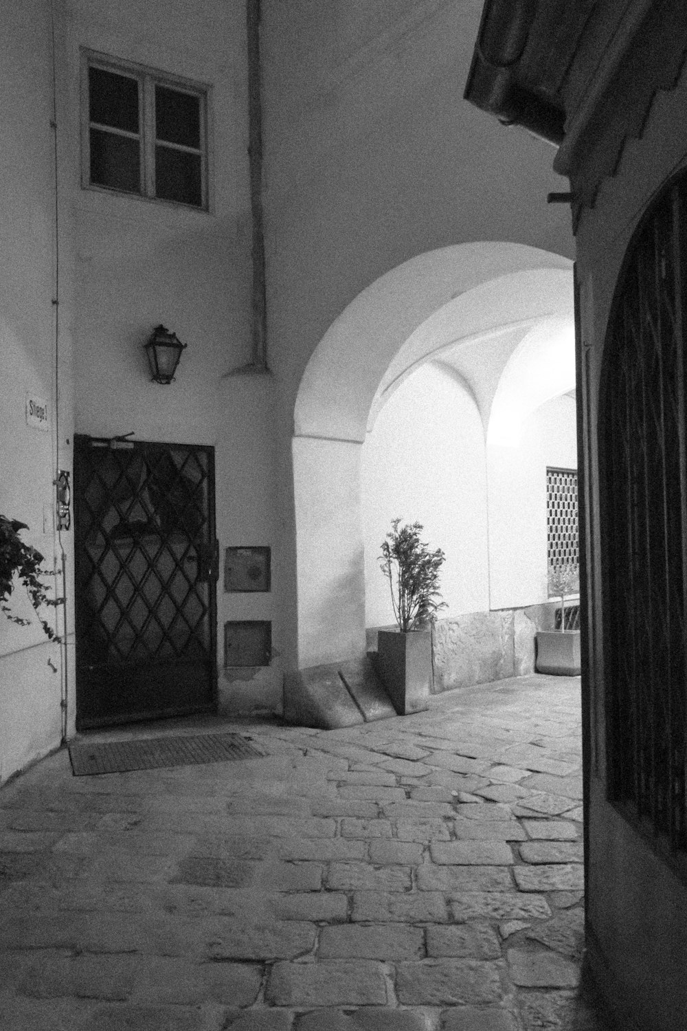 a black and white photo of an alley way