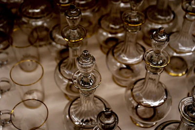 Elegant arrangement of decant bottles with golden caps reflecting soft light.