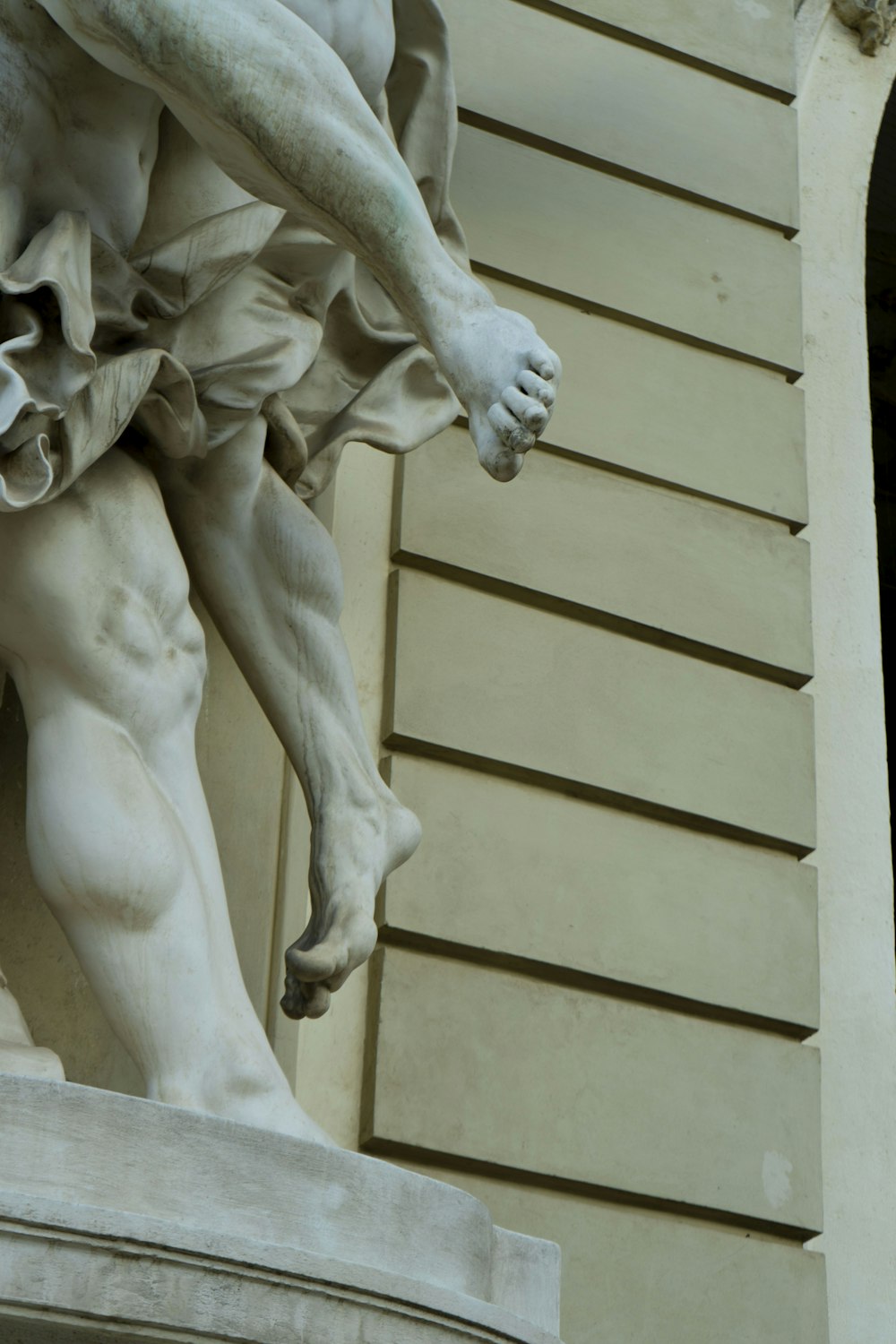 a close up of a statue of a man holding a dog