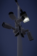 A security camera being mounted above a home entrance at dusk