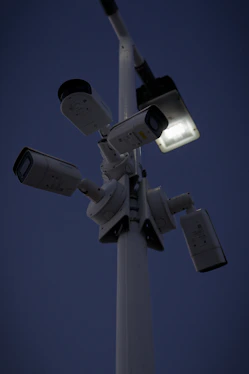 High-definition security camera monitoring a condominium entrance at night.