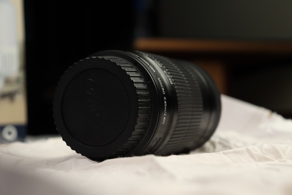 a close up of a camera lens on a bed