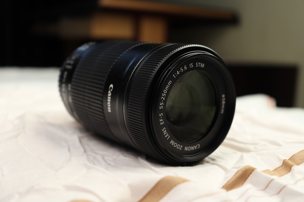 a close up of a camera lens on a bed