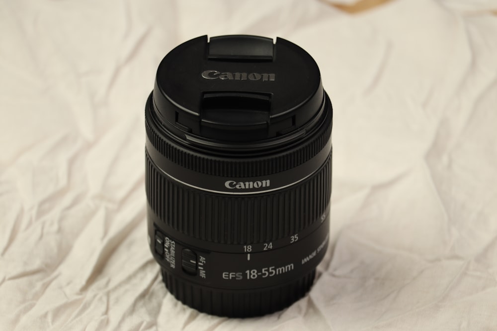 a camera lens sitting on top of a white sheet