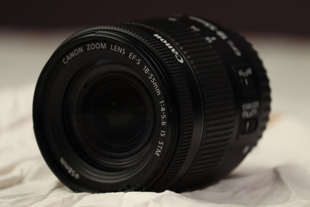 a close up of a camera lens on a bed