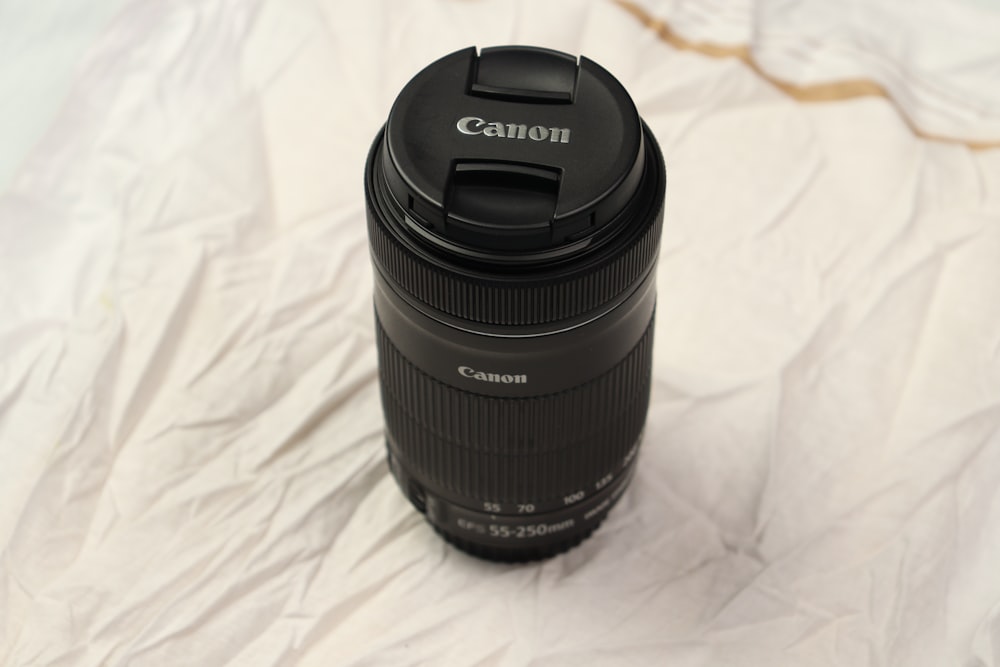 a camera lens sitting on top of a white sheet