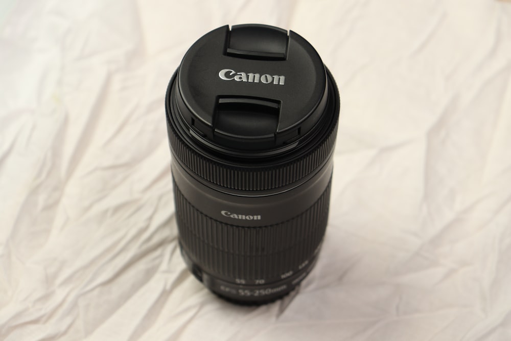 a camera lens sitting on top of a white sheet