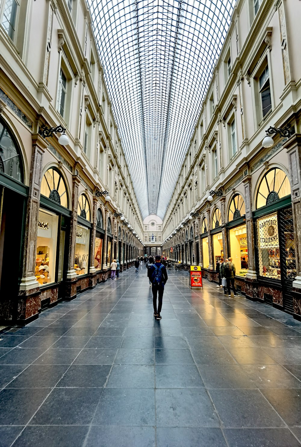 a person is walking down a shopping mall