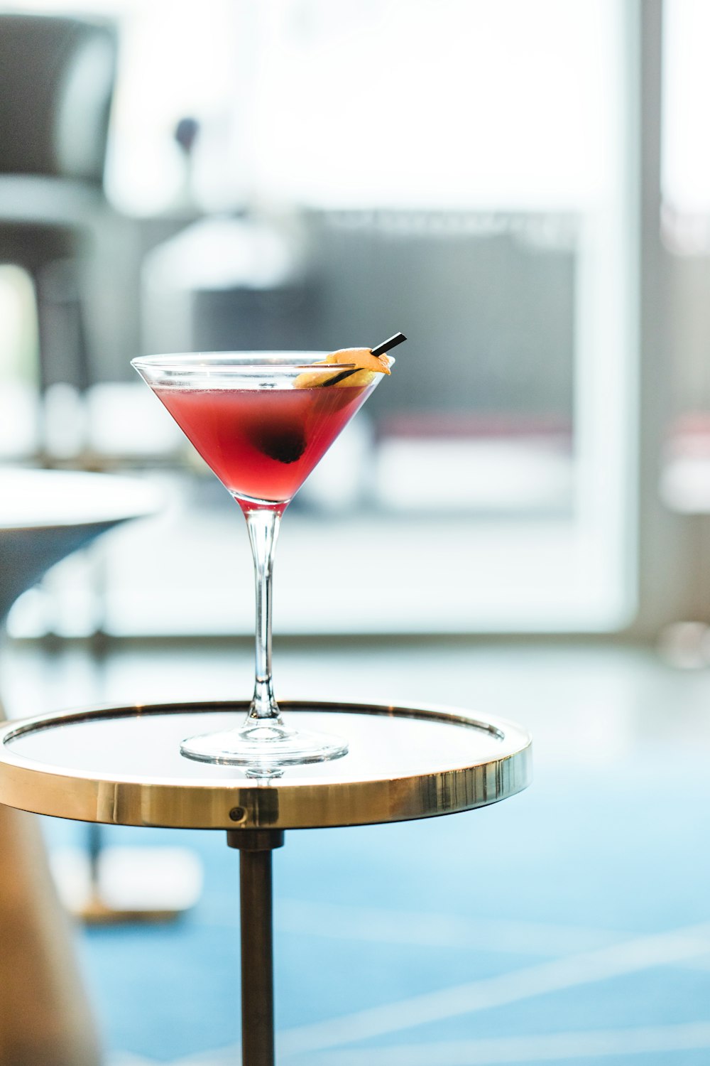 a red cocktail sitting on top of a table