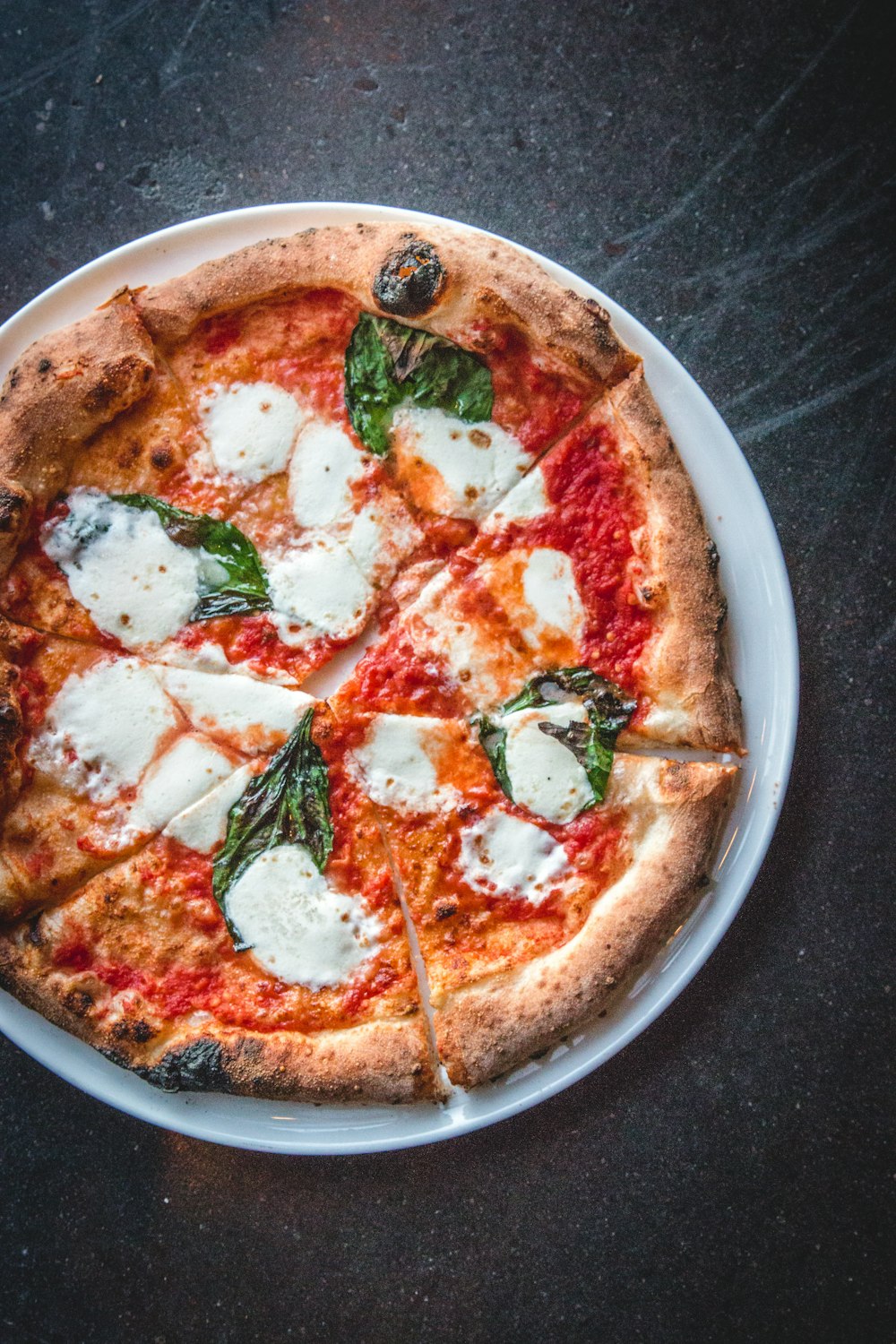 a pizza on a white plate on a table