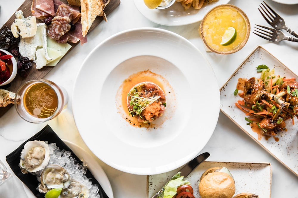 a table topped with plates of food and drinks