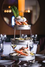 A vibrant seafood platter showcasing crab legs, shrimp, and oysters on a rustic wooden table.